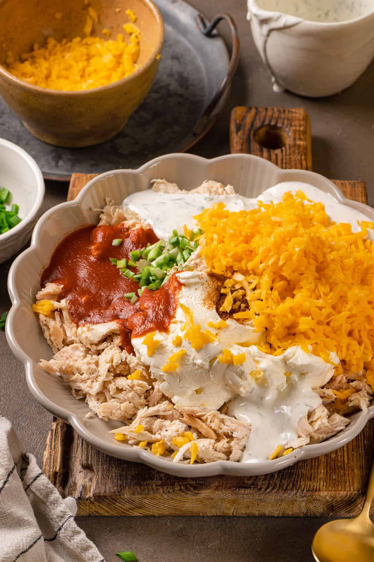 Ingredients for Buffalo chicken dip in a bowl.