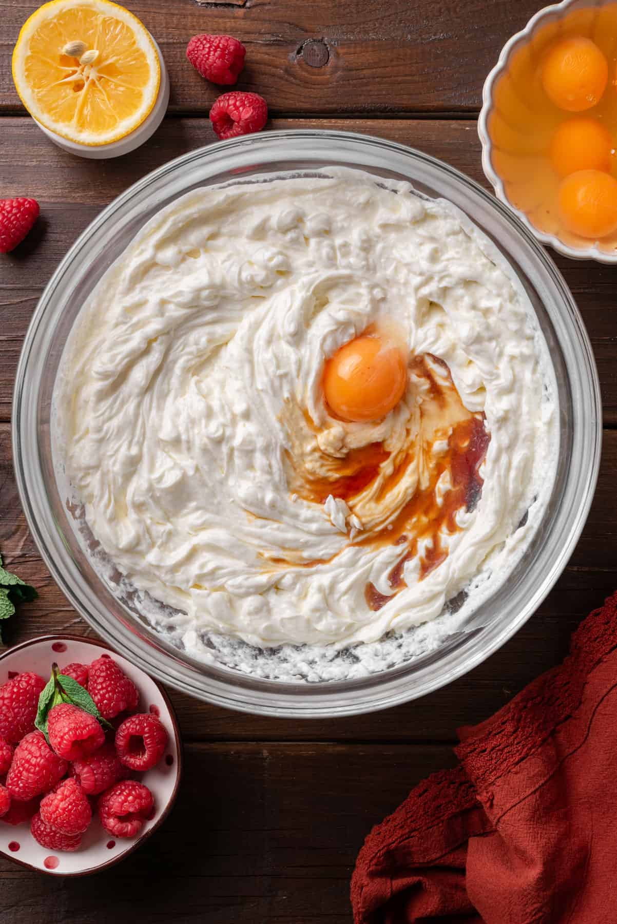add eggs and vanilla to the cream cheese, sour cream, and sugar mixture in a bowl.