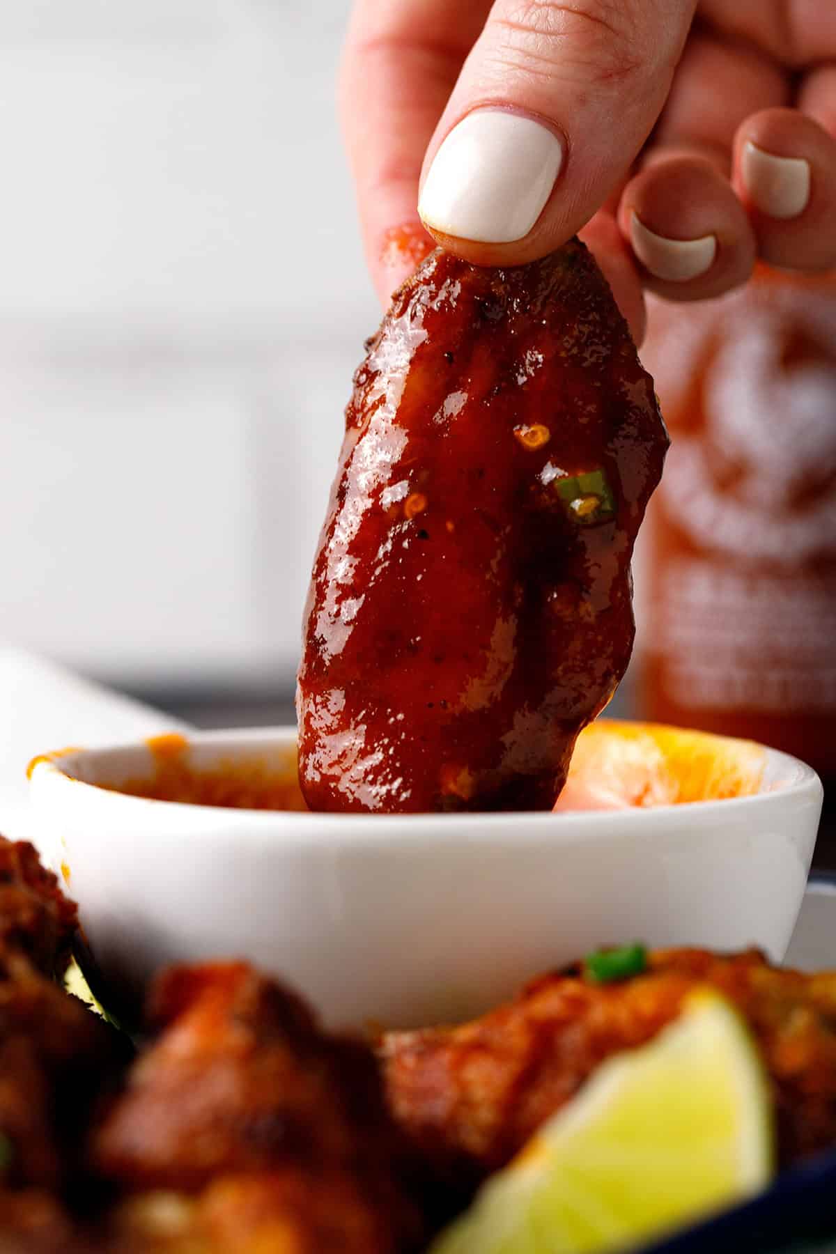chicken wing dipped in honey-sriracha sauce.