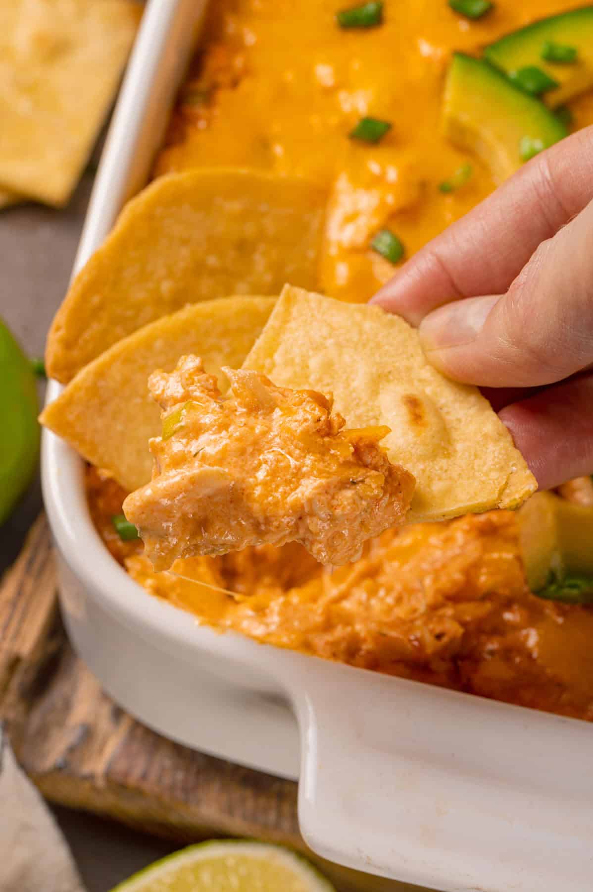 Buffalo chicken dip with tortilla chips in a baking dish.