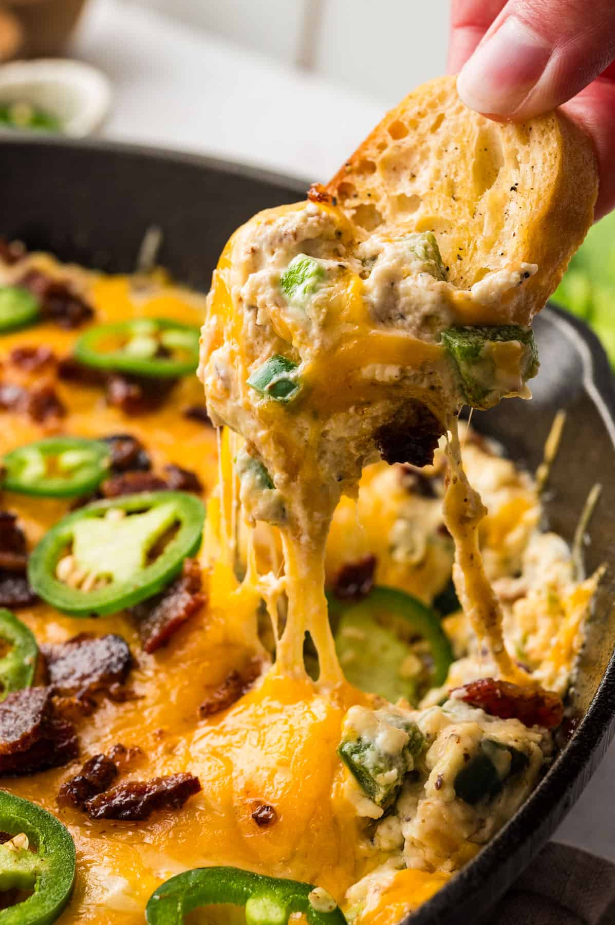 Jalapeno popper dip in a cast iron skillet.