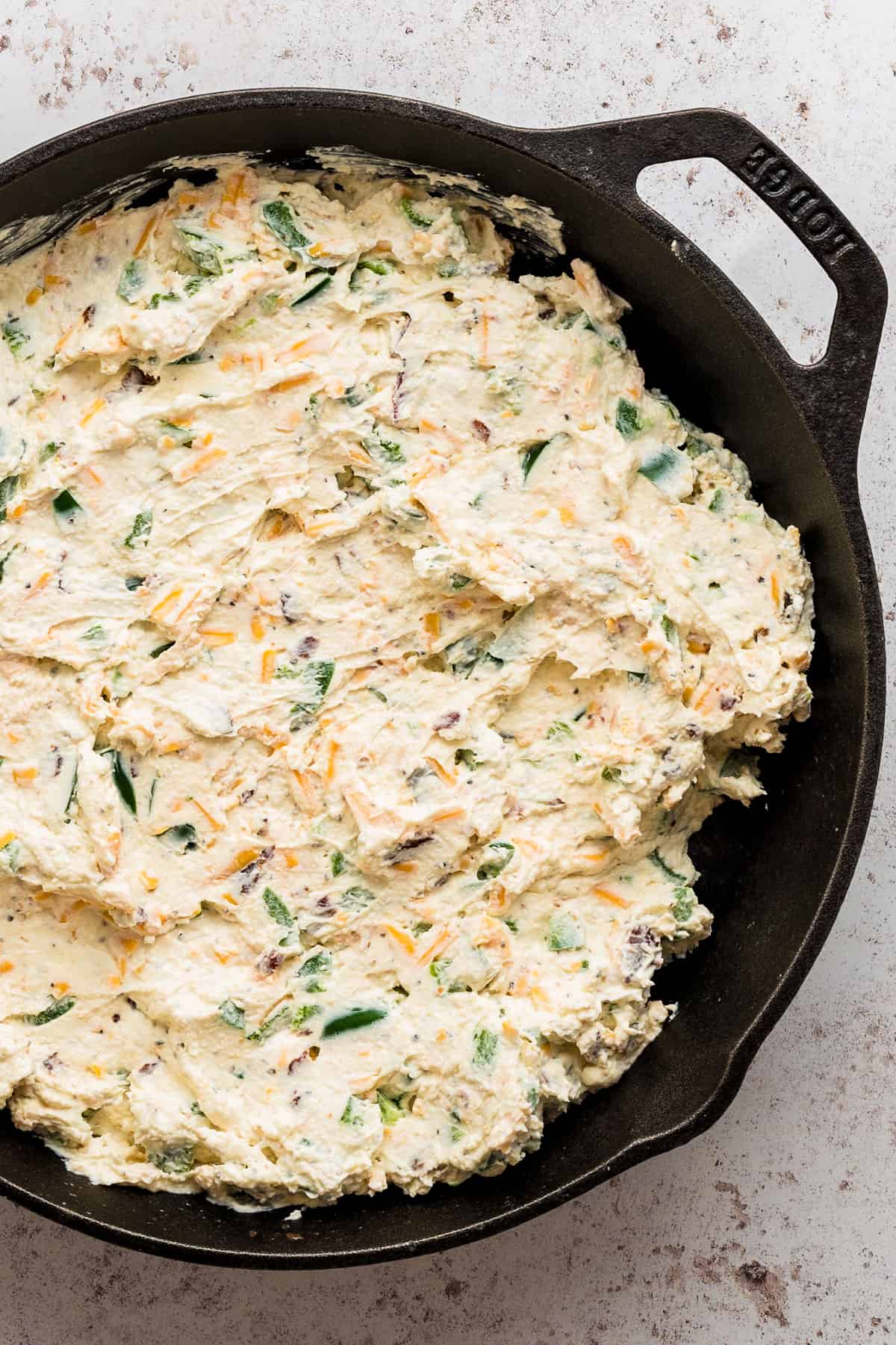 jalapeno popper dip in a cast iron skillet.