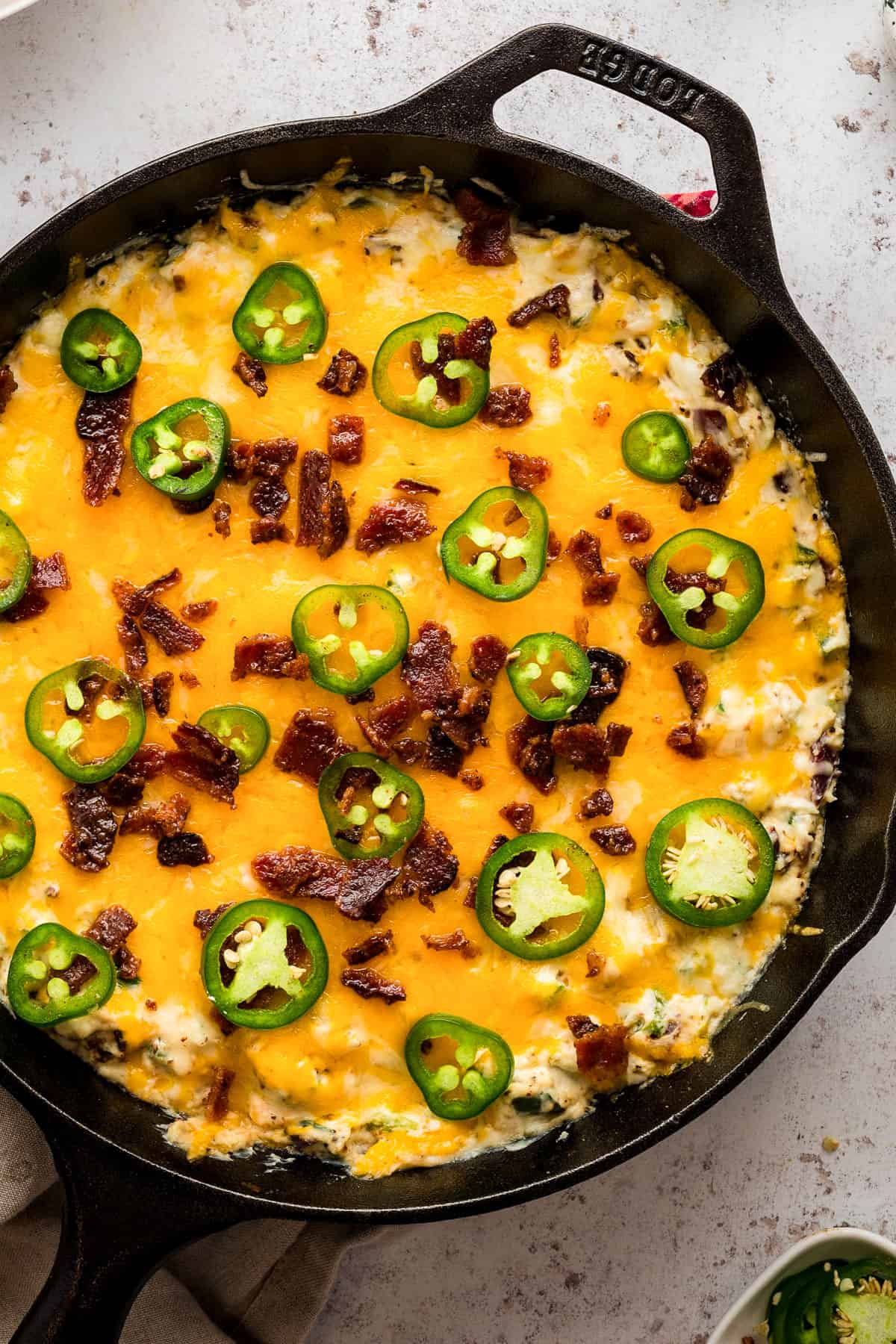 Jalapeno popper dip in a cast iron skillet.
