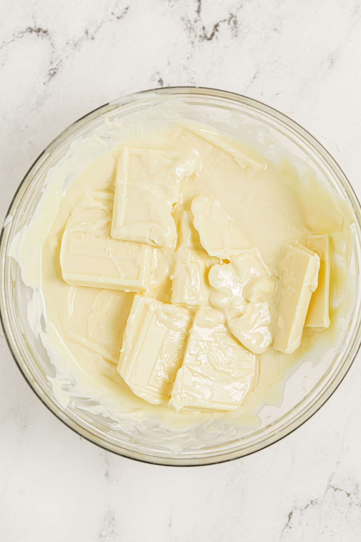 Melting white chocolate with coconut oil in a mixing bowl.