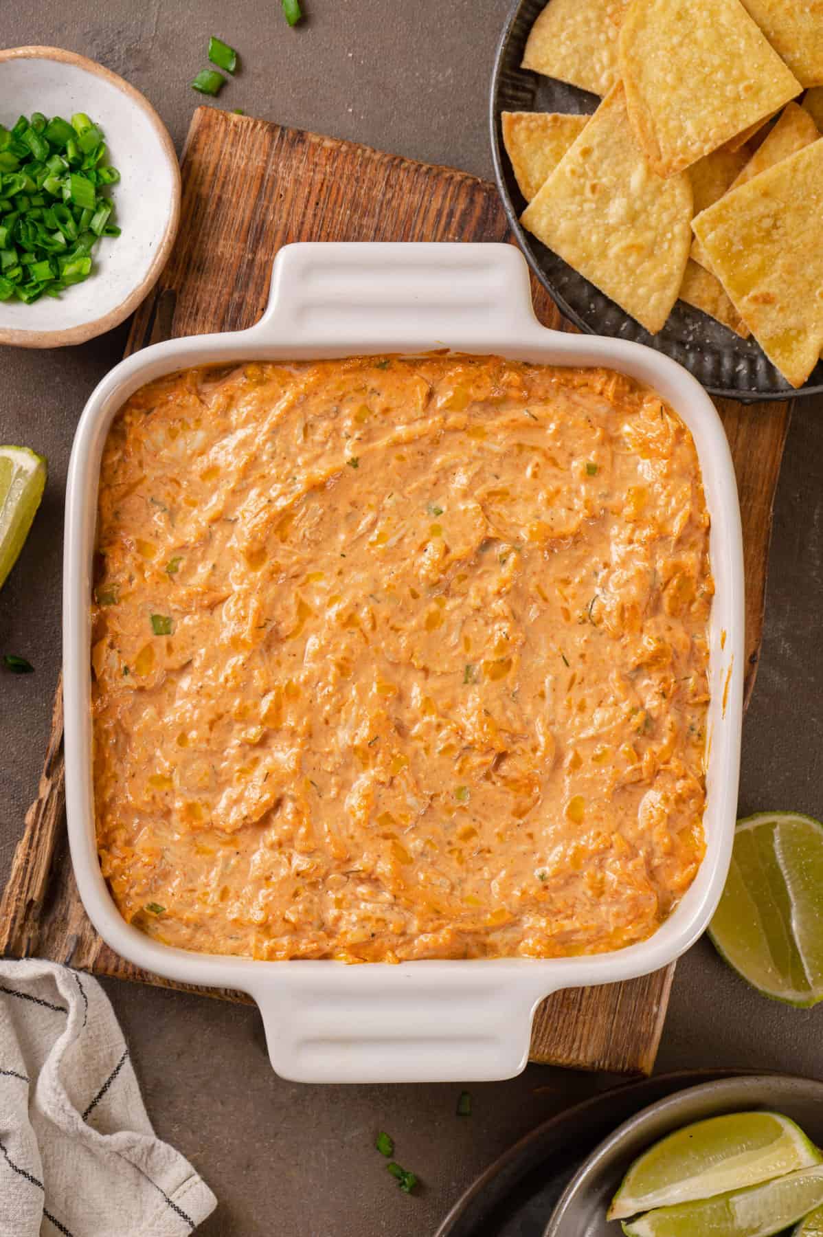 mixed ingredients for Buffalo chicken dip in a baking dish.