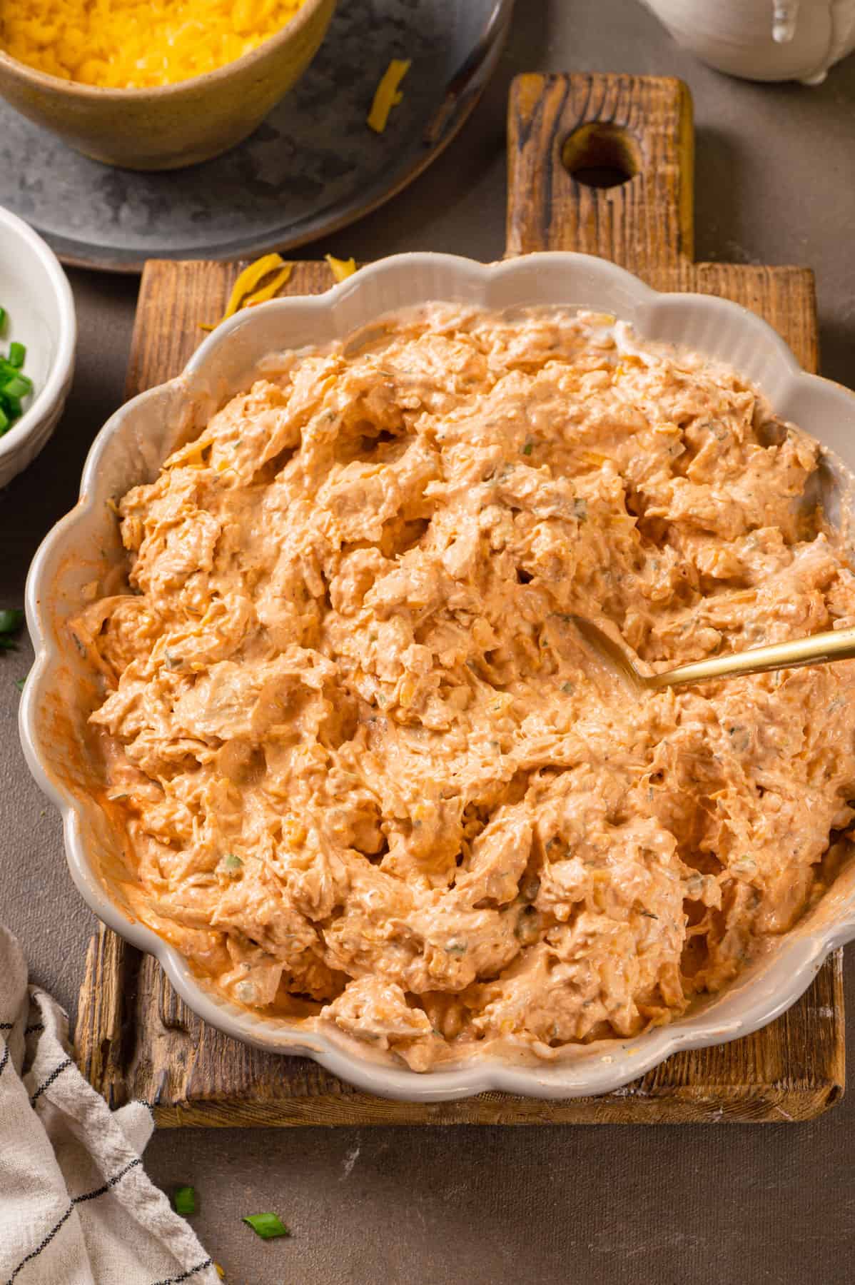 mixed ingredients for Buffalo chicken dip in a bowl.