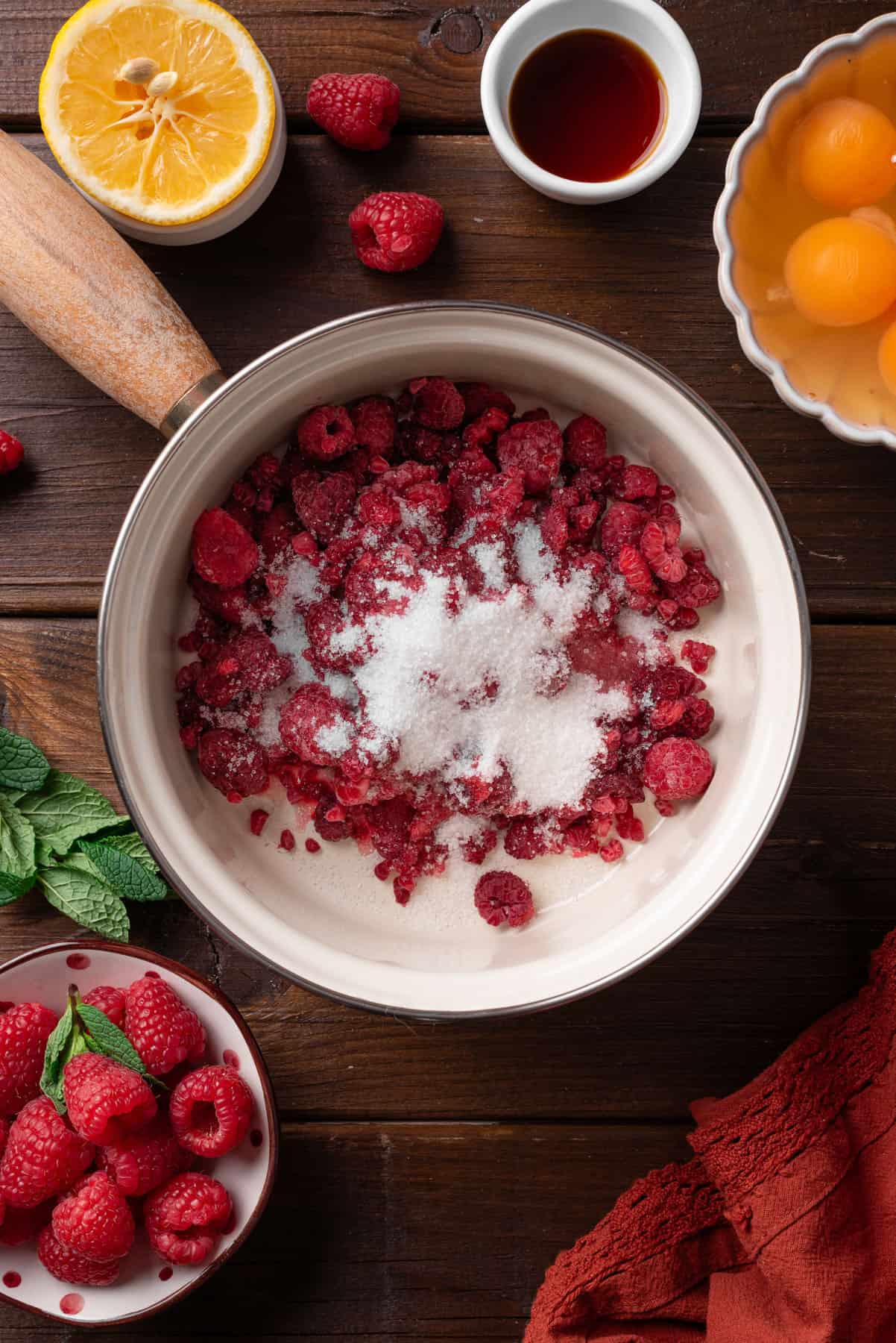 Raspberries with sugar in a small pot.