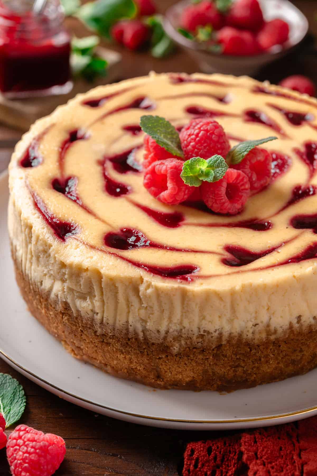 Raspberry cheesecake on a cake platter.