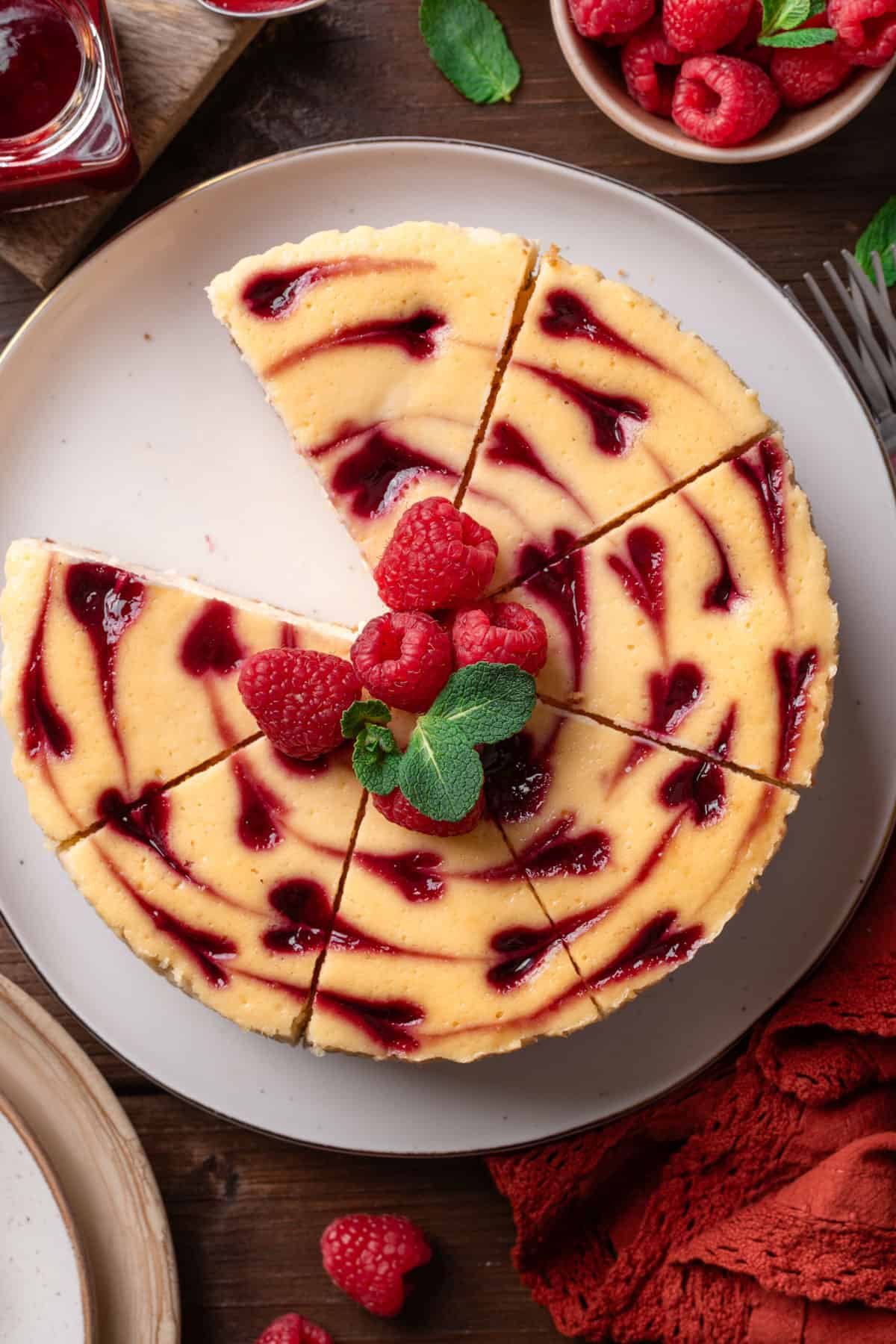 Raspberry cheesecake on a cake platter.