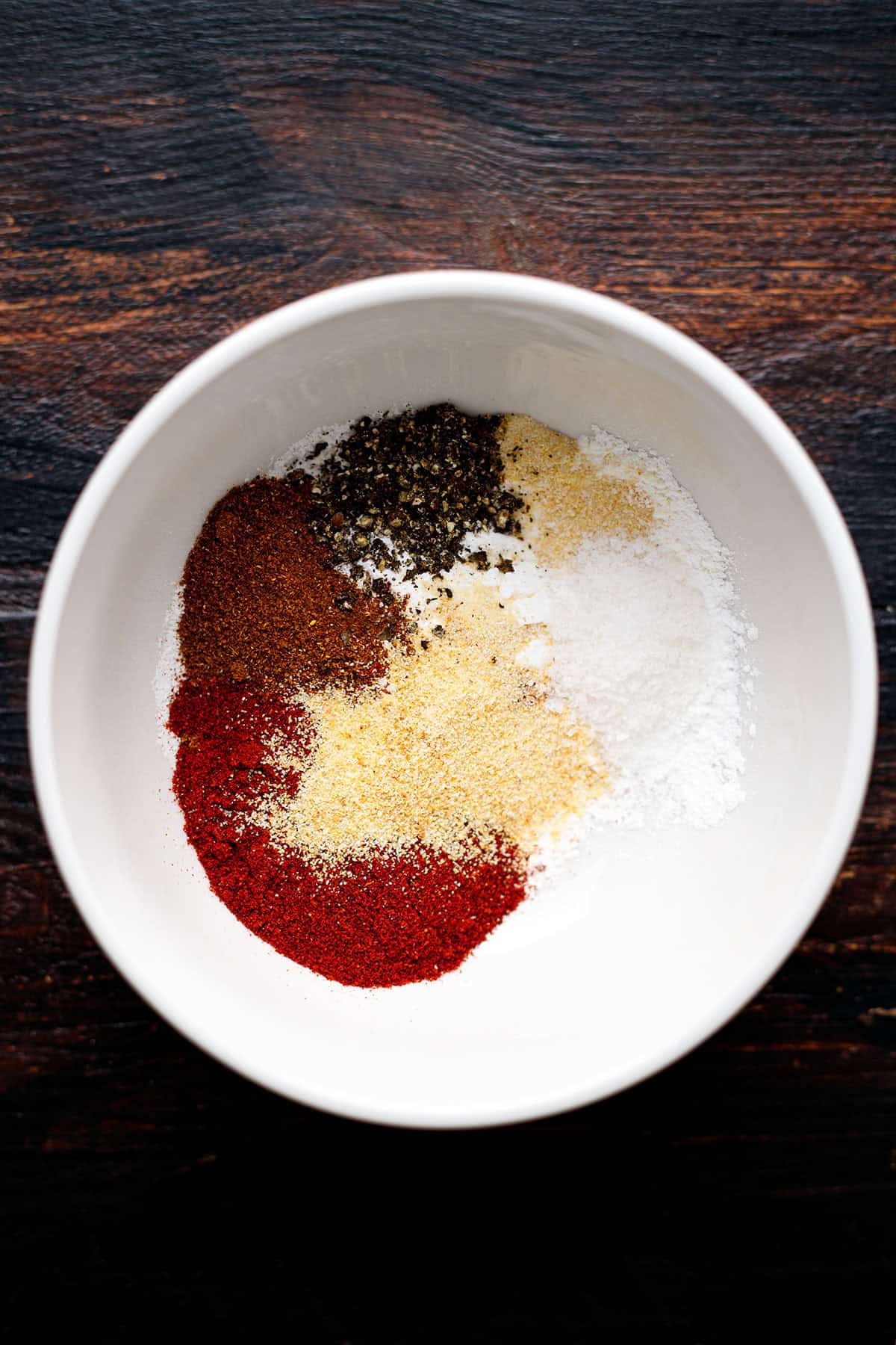 seasonings for chicken wings - in a white bowl.