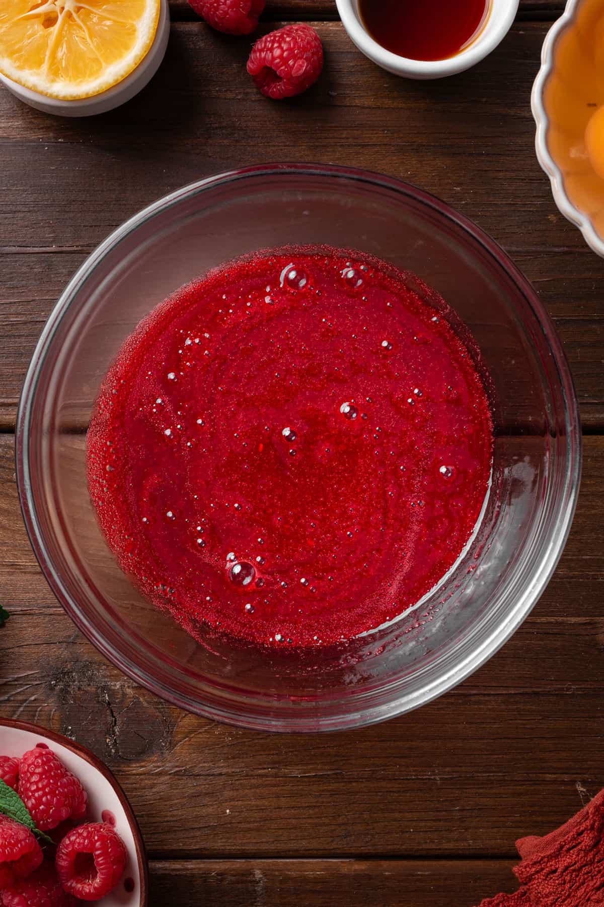 Strained raspberry sauce in a bowl.