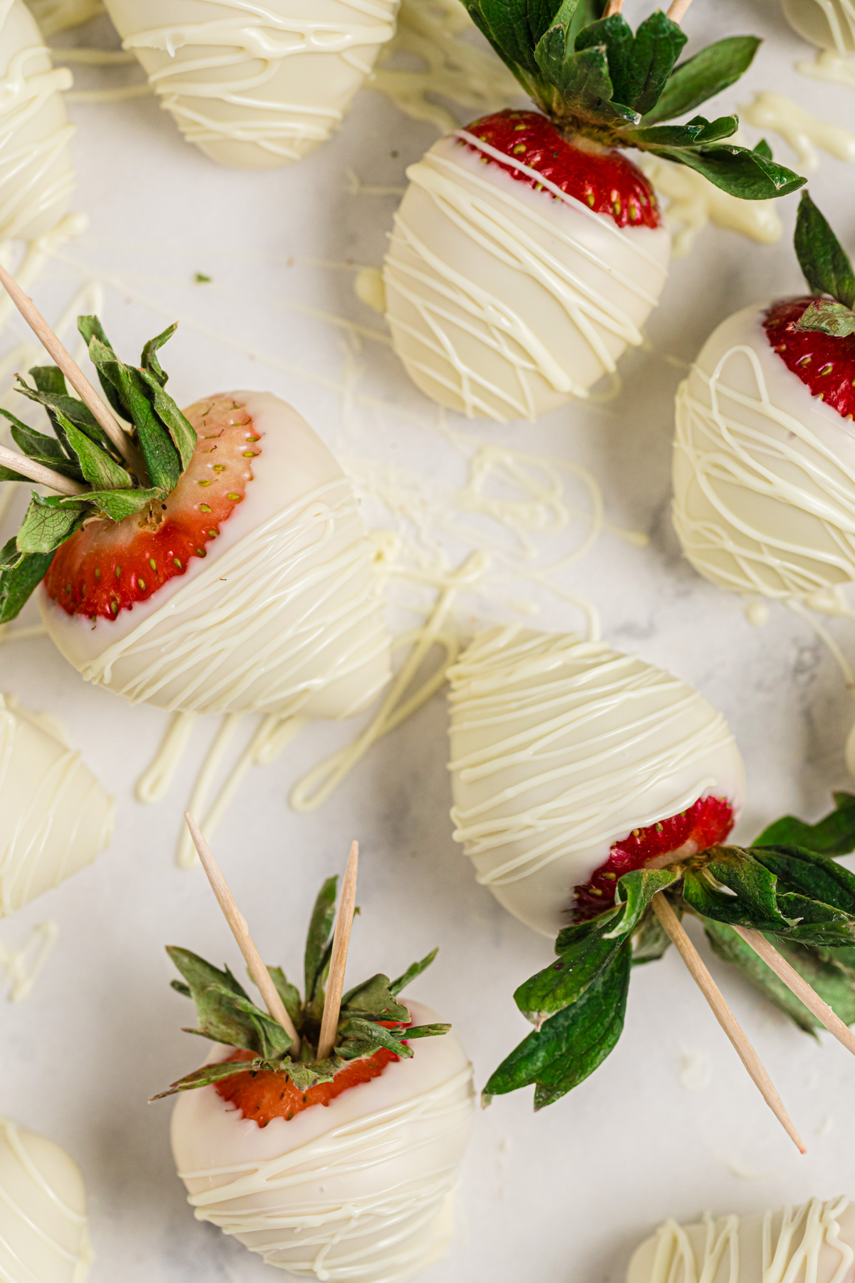 White chocolate covered strawberries drizzled with white chocolate.