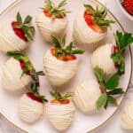 White chocolate covered strawberries - on a plate.