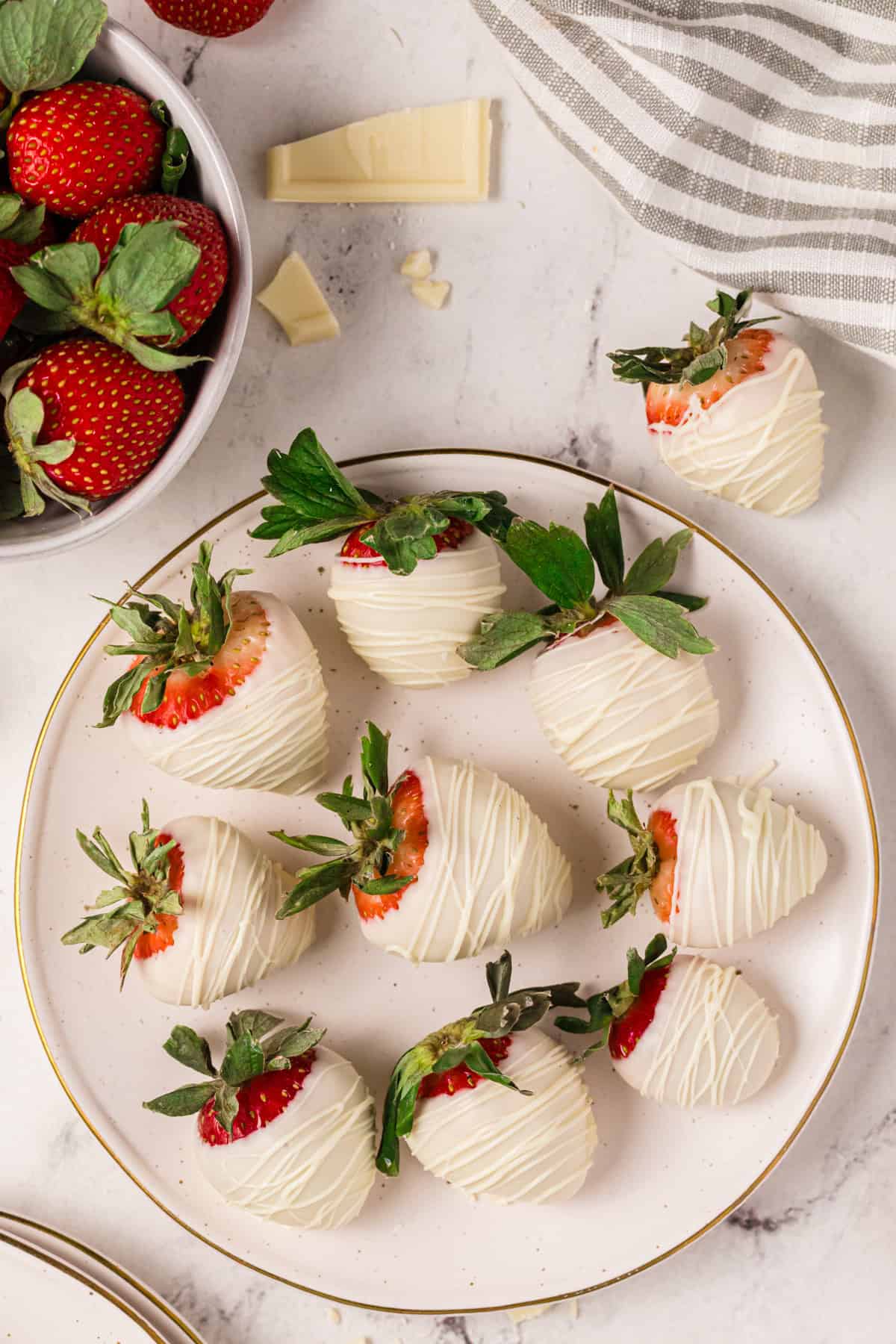 White chocolate covered strawberries - on a plate.
