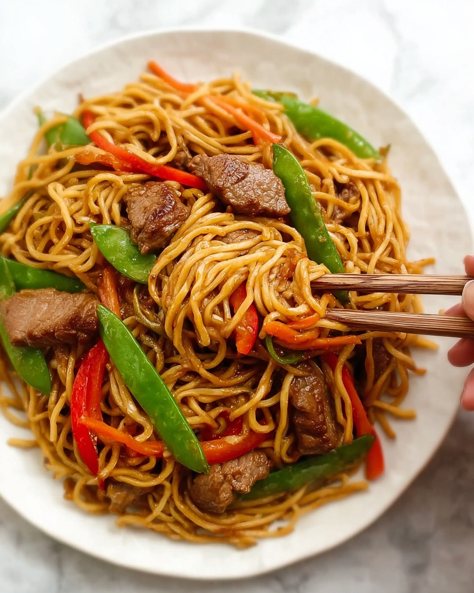 The image shows a close-up of a stir-fry noodle dish with three main layers. The bottom layer is made of bright yellow, slightly shiny noodles, forming a tangled texture that fills most of the space. On top of the noodles, there are several pieces of browned meat with a smooth, cooked texture and a slightly shiny surface. Scattered among the meat and noodles are bright green snap peas, thin red chili pepper slices, and pale green stalks of spring onion, adding fresh colors and a crunchier texture. The background is a white marbled surface. photo taken with an iphone --ar 4:5 --v 7