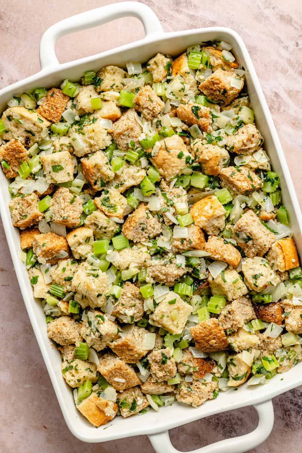 classic stuffing recipe with butter and fresh herbs in a casserole dish.