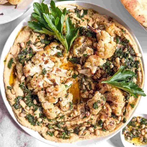 pverehad view of Crispy Roasted Cauliflower and Pine Nut Hummus in a bowl