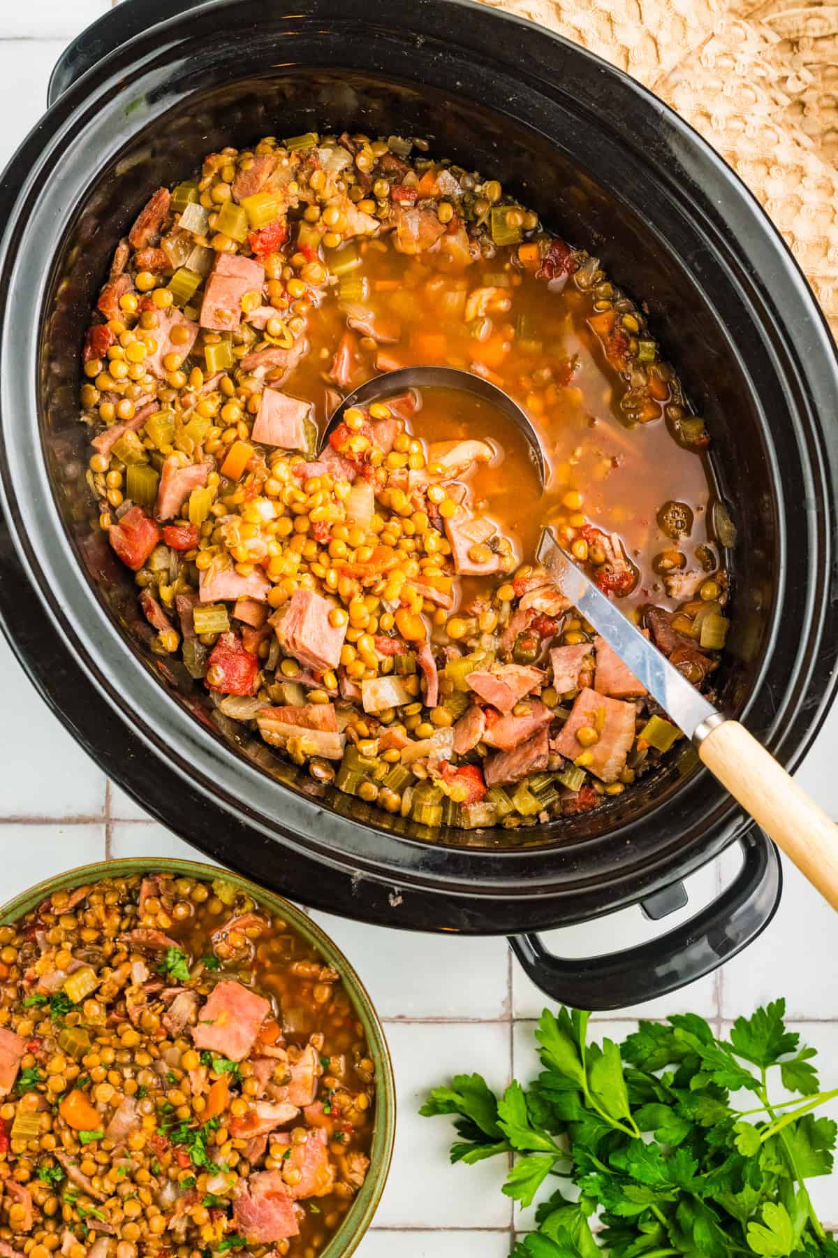 Slow Cooker Ham and Lentil Soup. Ham and Lentil Soup in a black slow cooker.
