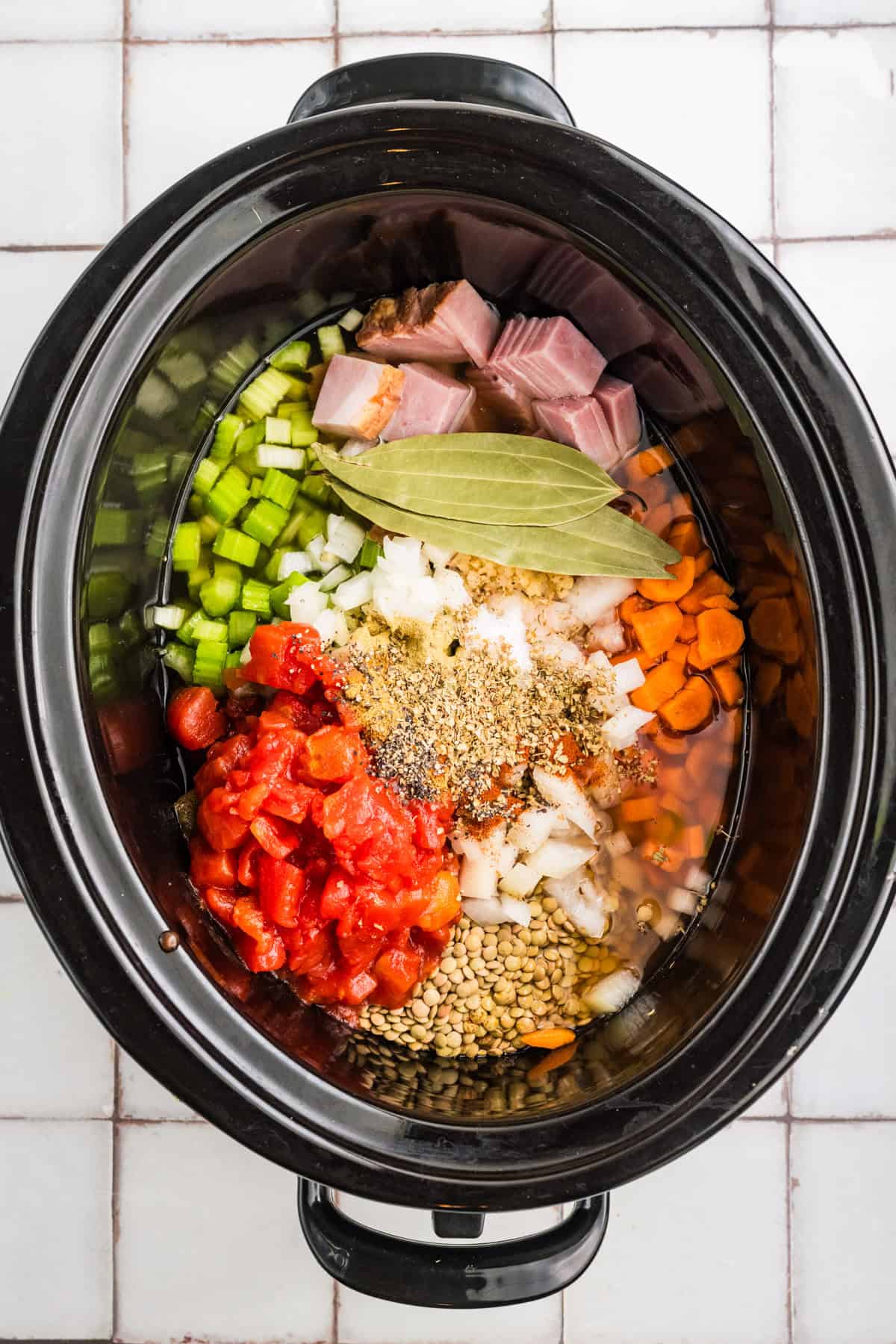 Slow Cooker Ham and Lentil Soup All the ingredients for Ham and Lentil soup in a black Slow Cooker.