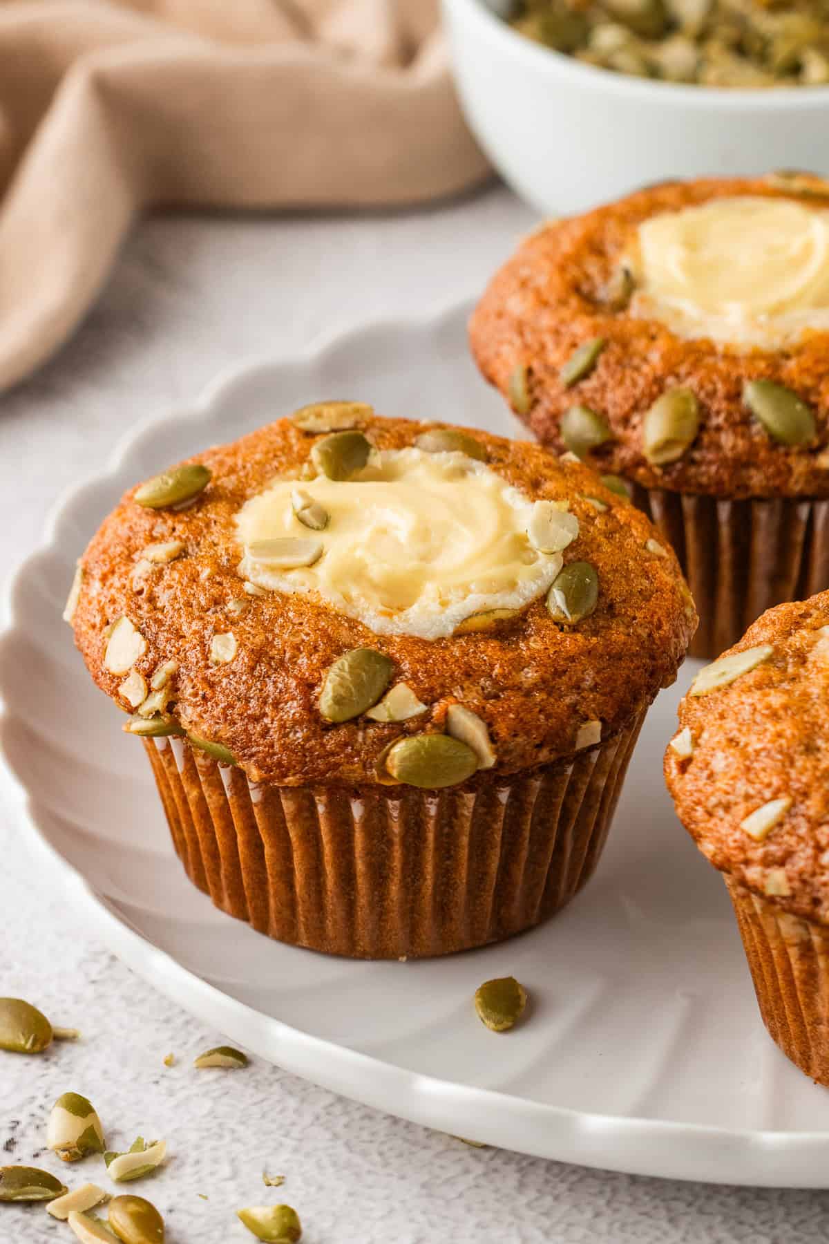 Pumpkin Cream Cheese Muffins on a white plate.