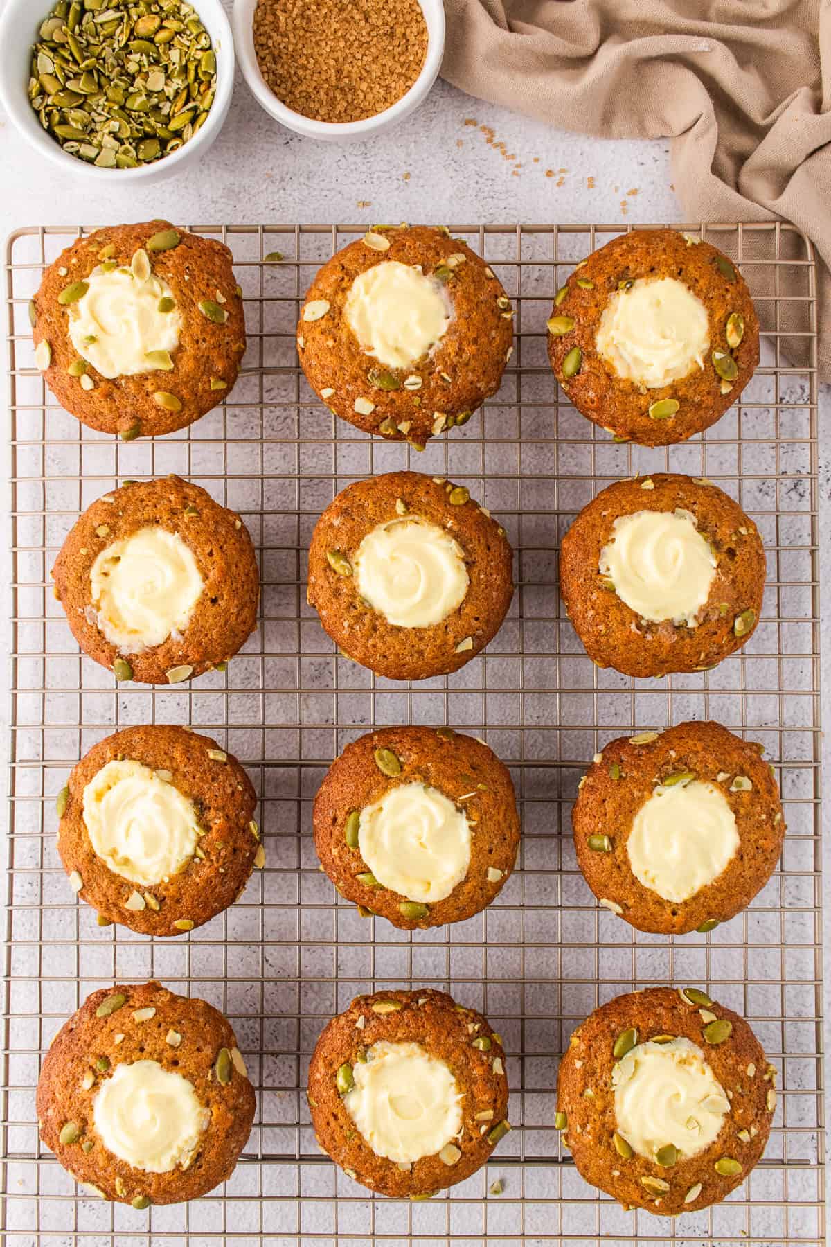 12 Pumpkin Cream Cheese Muffins on a rack.