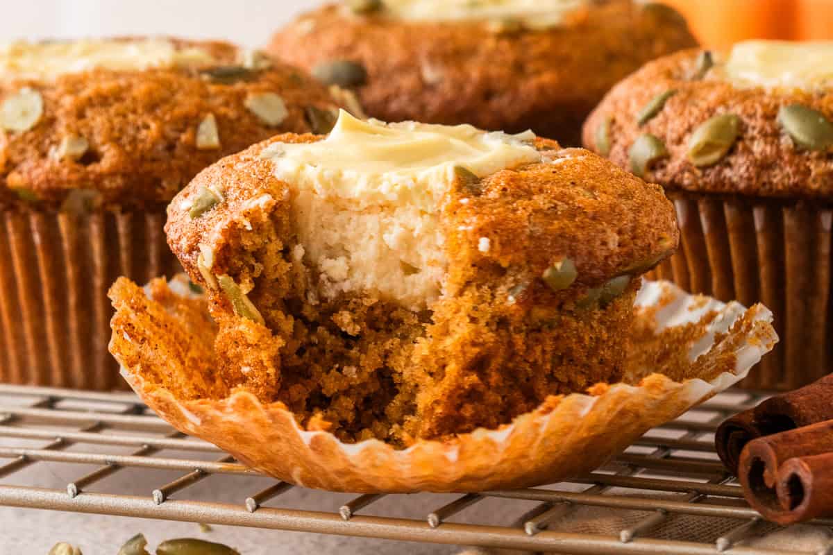 Pumpkin Cream Cheese Muffins (with a small bite out).