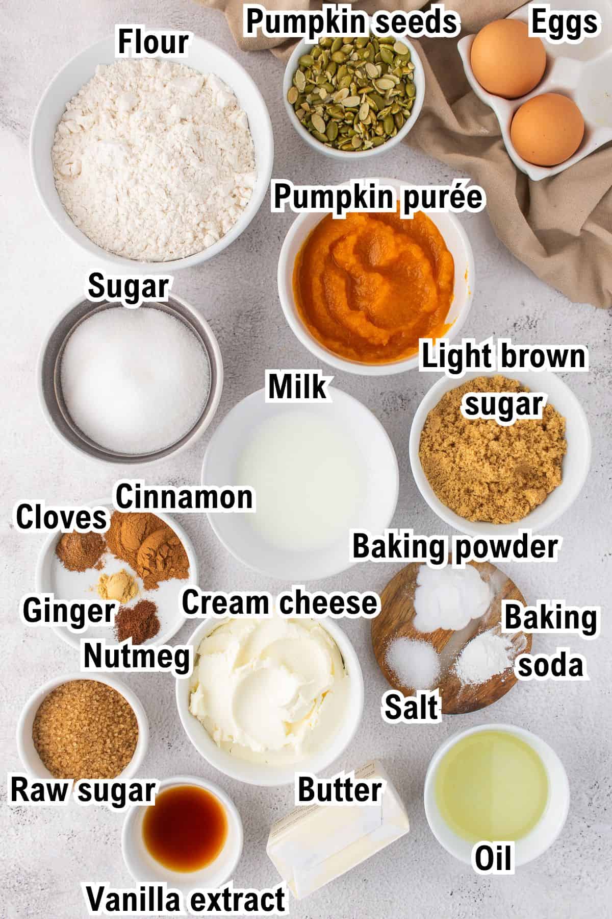 This photo shows all the ingredients (labeled) required for Pumpkin Cream Cheese Muffins.