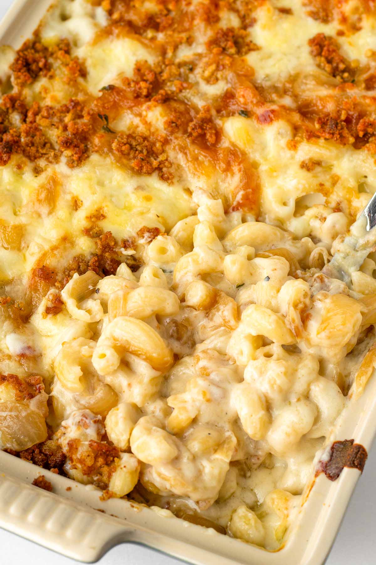 creamy french onion mac and cheese baked in a ceramic casserole