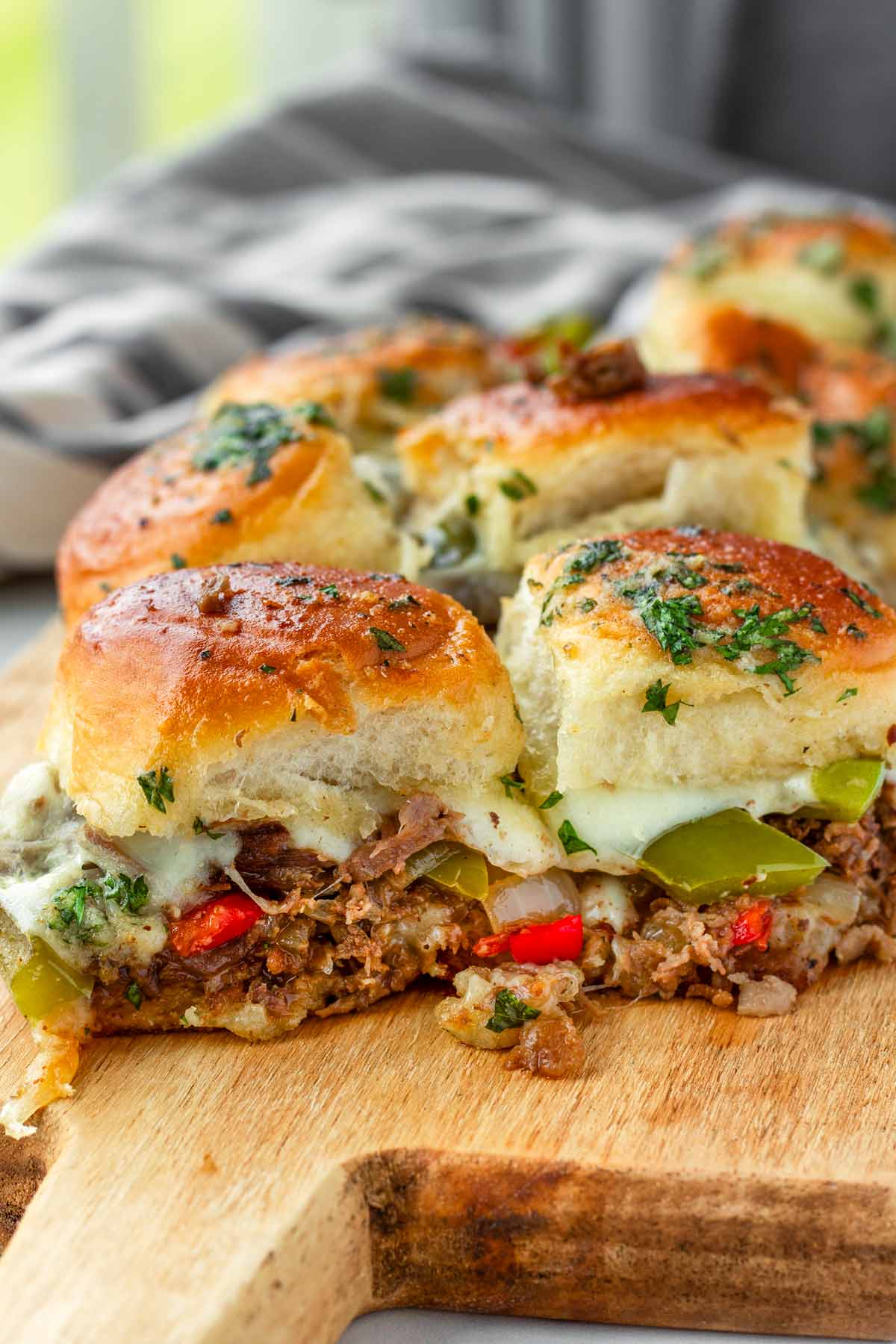 philly cheesesteak slider buns on a board