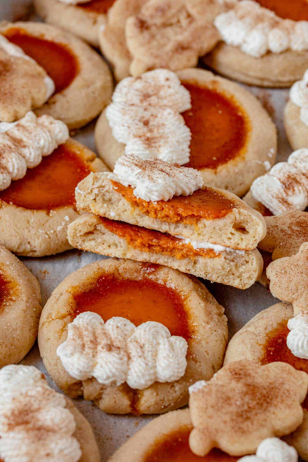a pumpkin pie cookie cut in half showing the creamy pumpkin spice center.